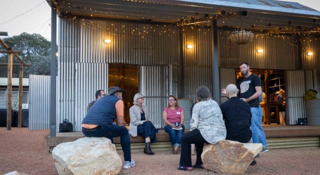 Group of adults sitting in a circle talking